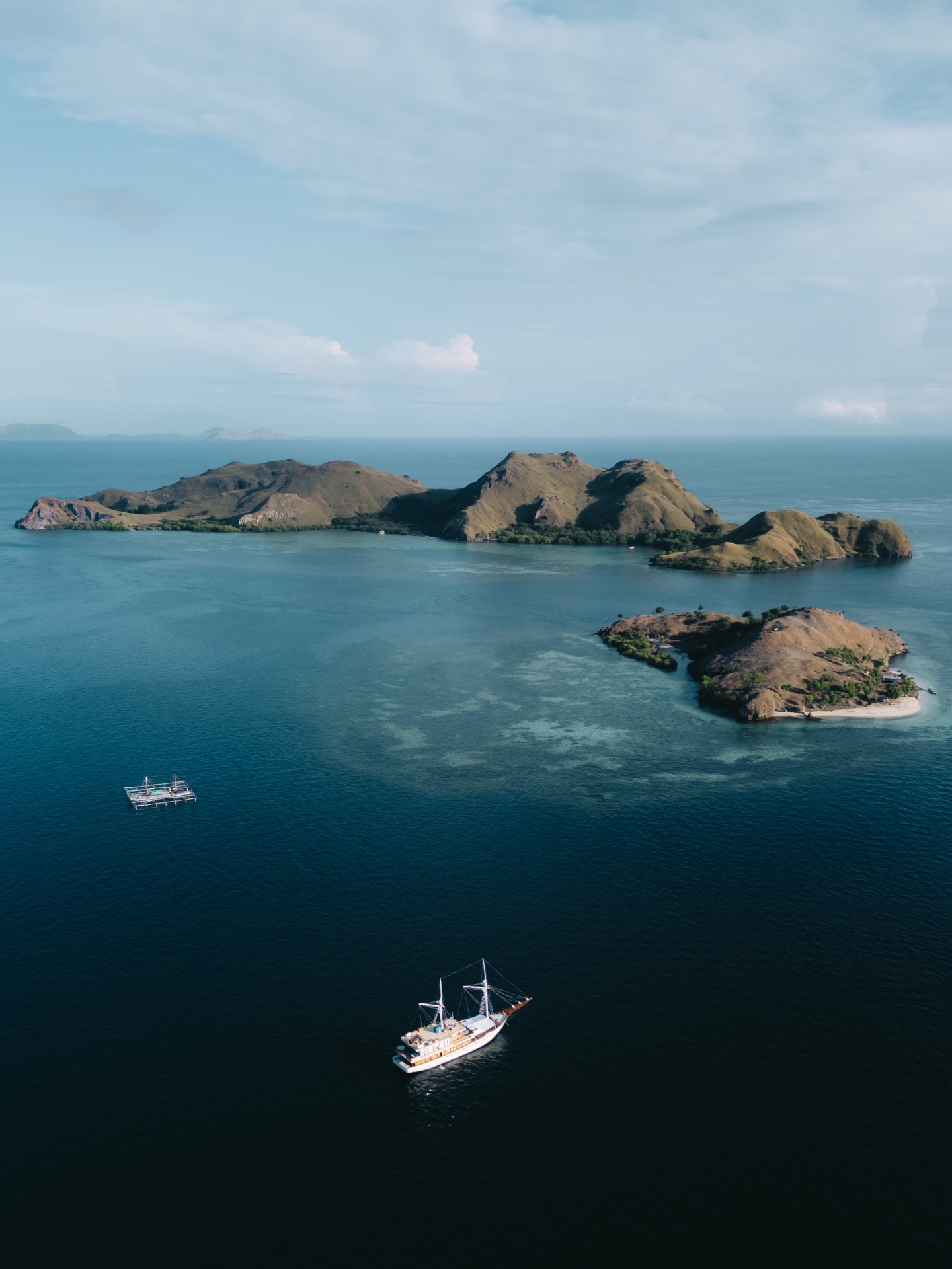 Aerial view of islands with a traditional sailing boat