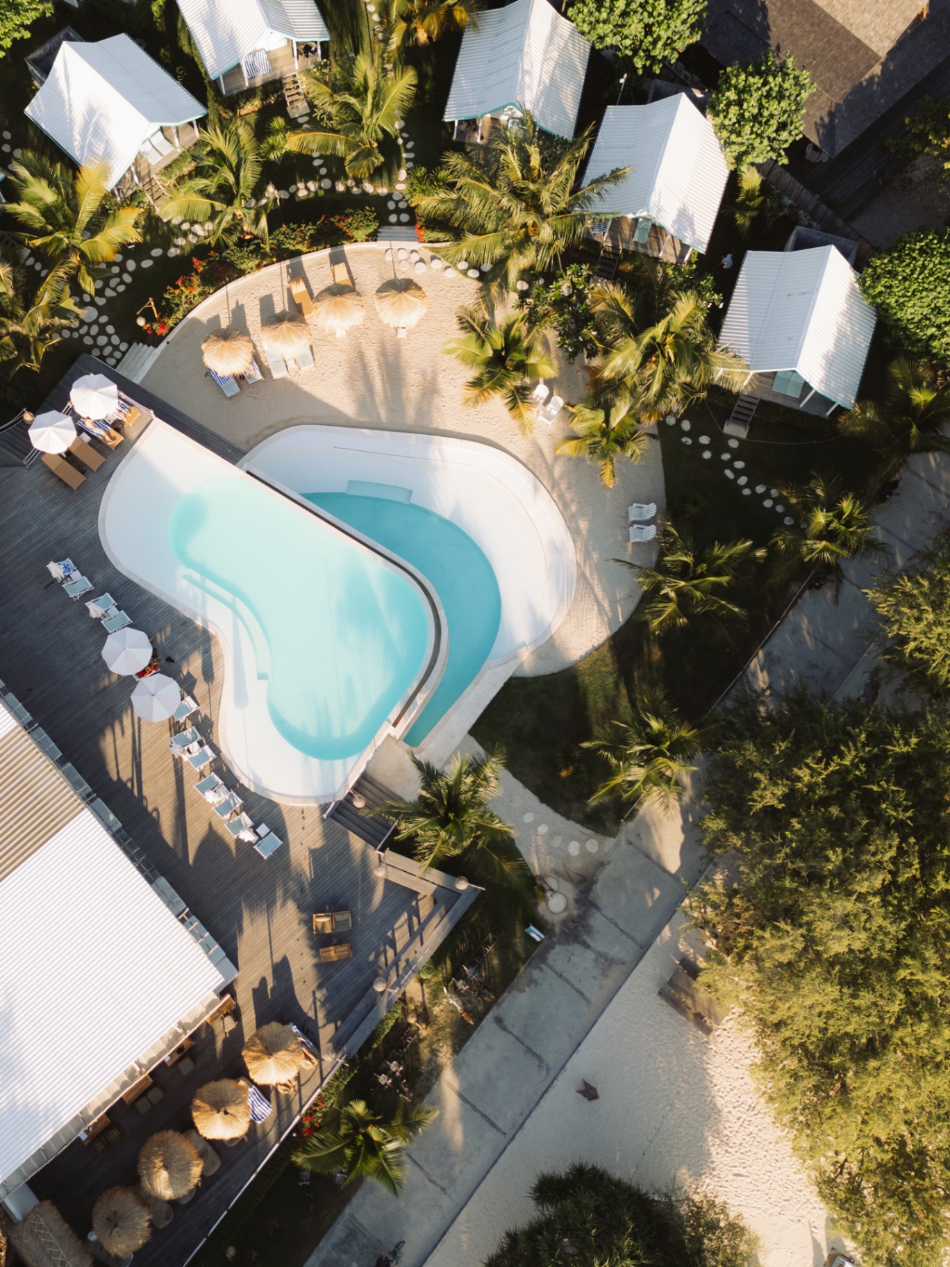 Aerial view of a resort pool and villas